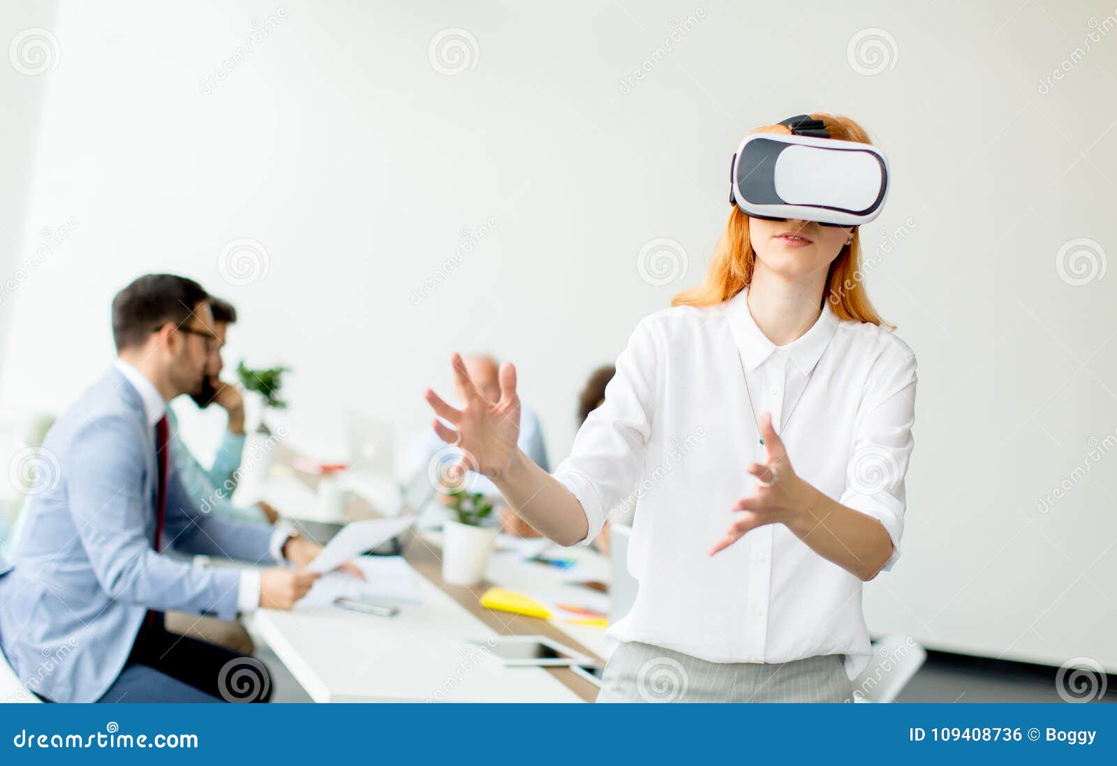 Young Woman Using Virtual Reality Simulator in the Office Stock Photo