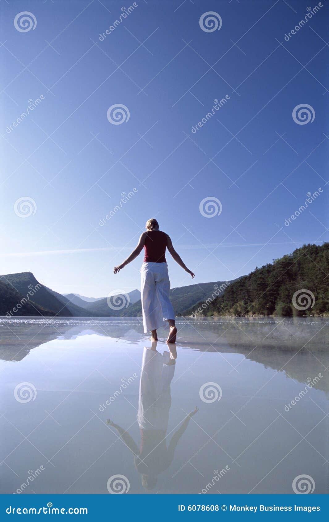 young woman wading in lake
