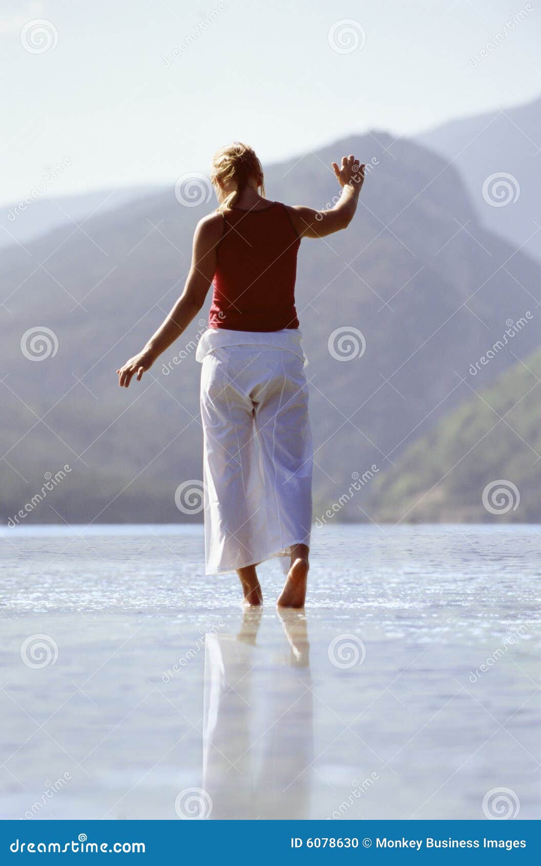 young woman wading in lake