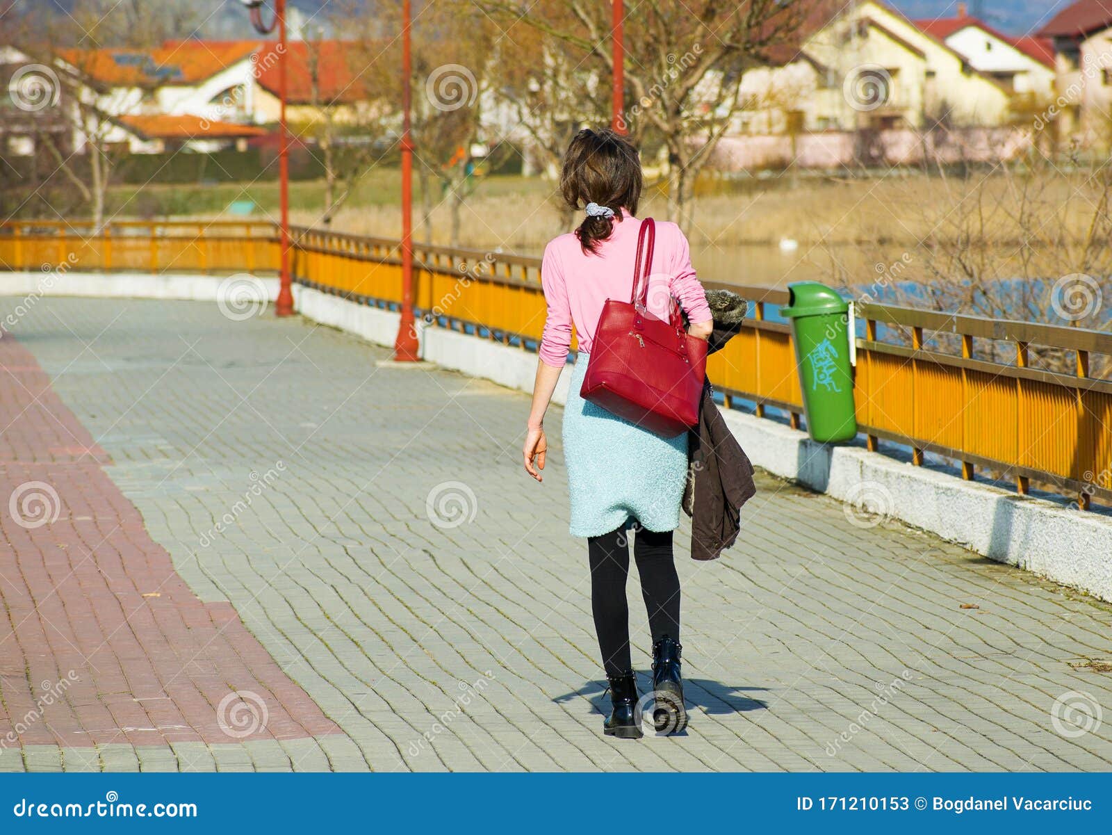 The Young Woman is Walking on the Alley in the Park, on the Edge of the ...