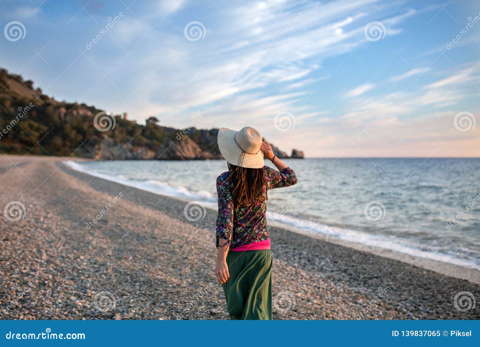 young woman walking on the beach, cala del caÃÂ±uelo, andalusia