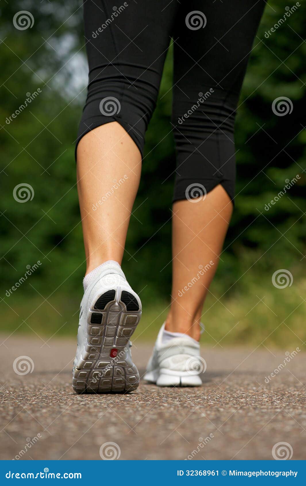 Young Woman Walking Outdoors In Park From Behind Stock Image - Image