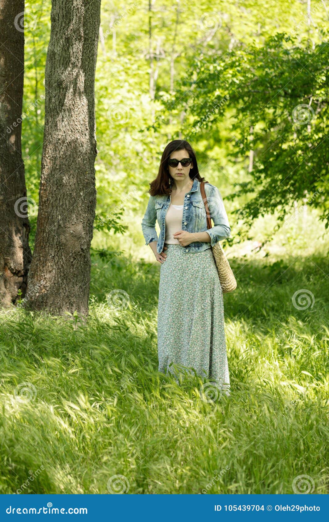 Young Woman is Walking in a Park in a Long Skirt with a Floral P Stock ...