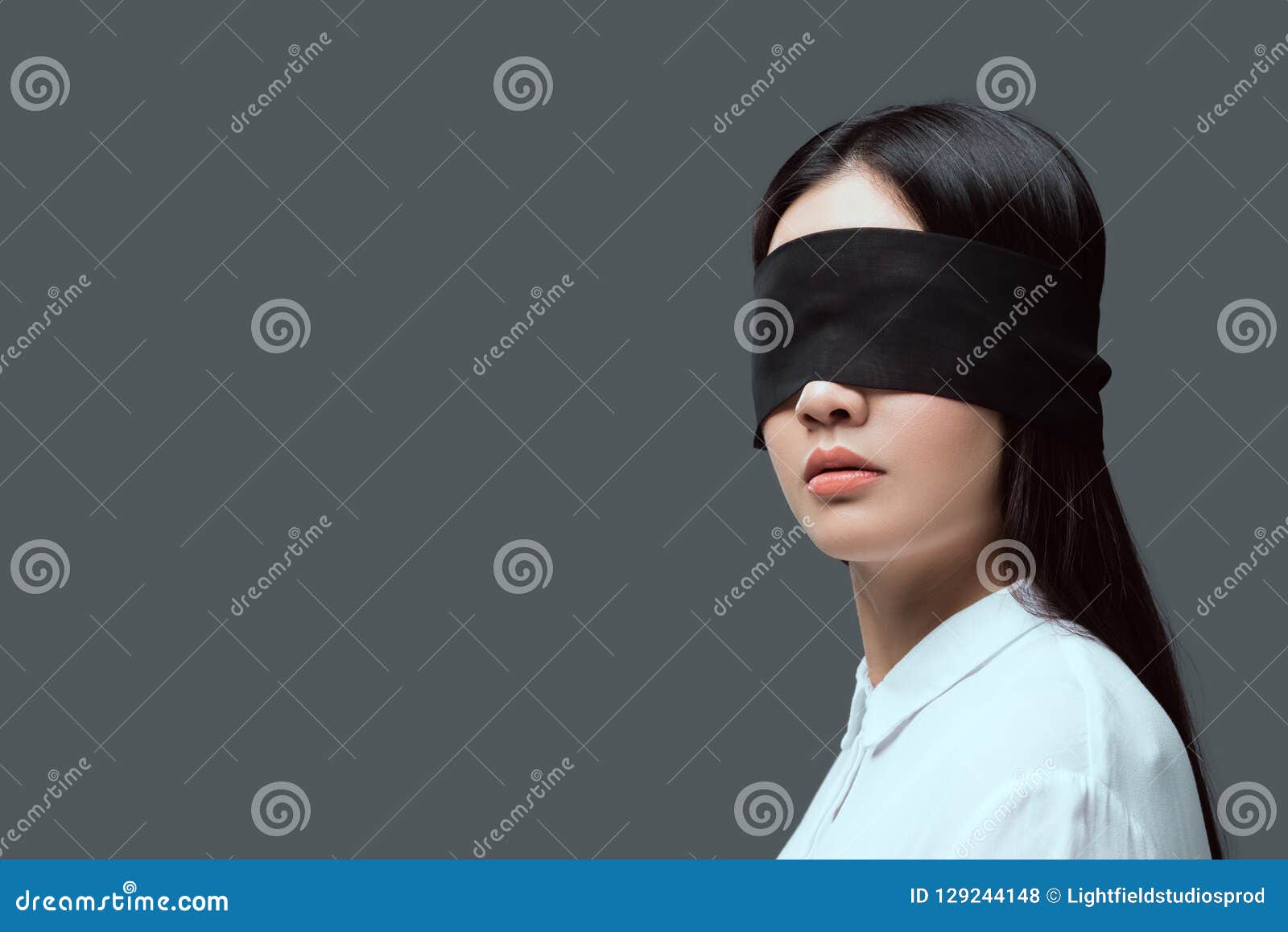 young woman wearing black blindfold