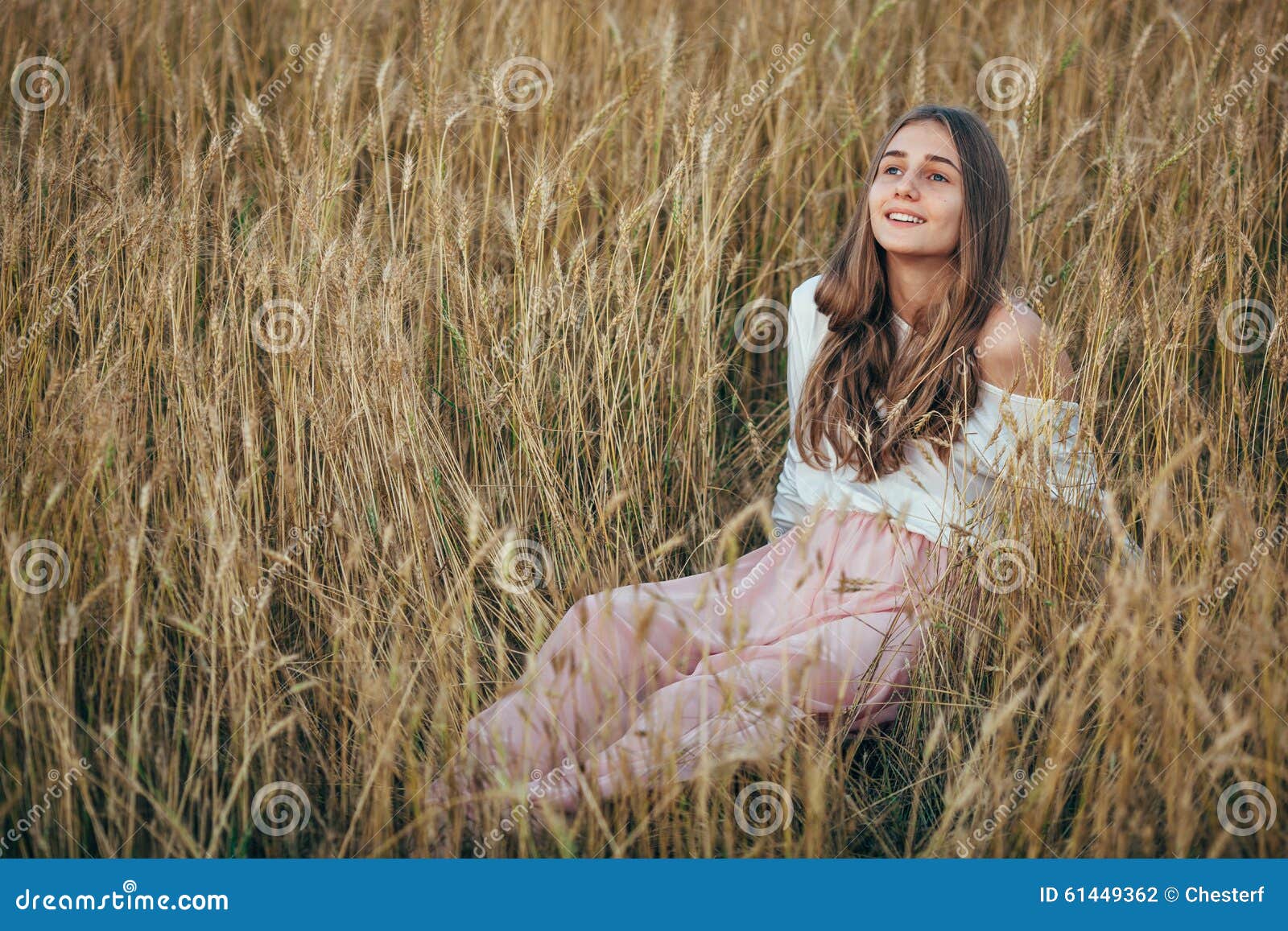 The Young Girl Posing Sitting In A Wheat Field, Hands 