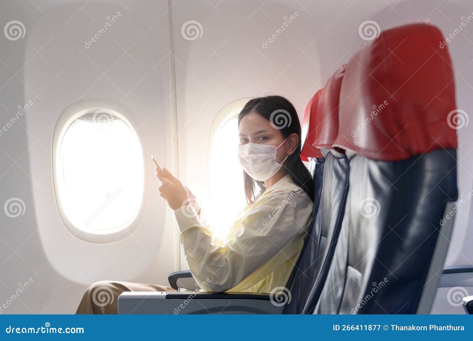 Young Woman Wearing Face Mask is Traveling on Airplane , New Normal ...