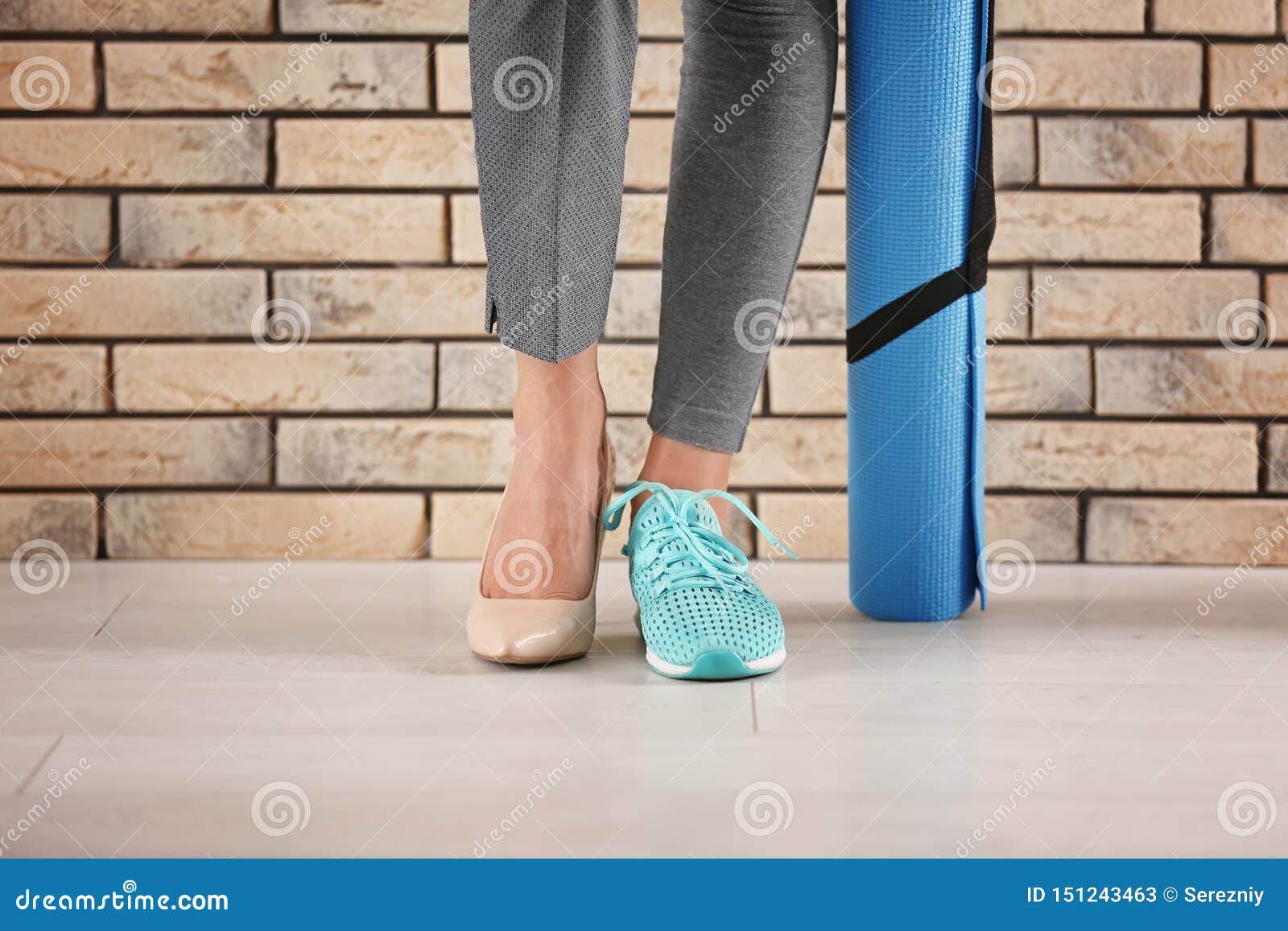 Woman Holding Paper Bag Against Brick Wall Stock Photo 