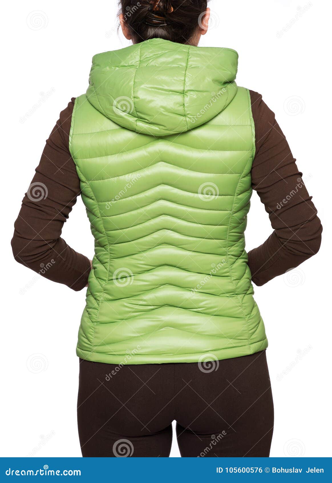 young woman wearing light green hooded packable down puffer vest