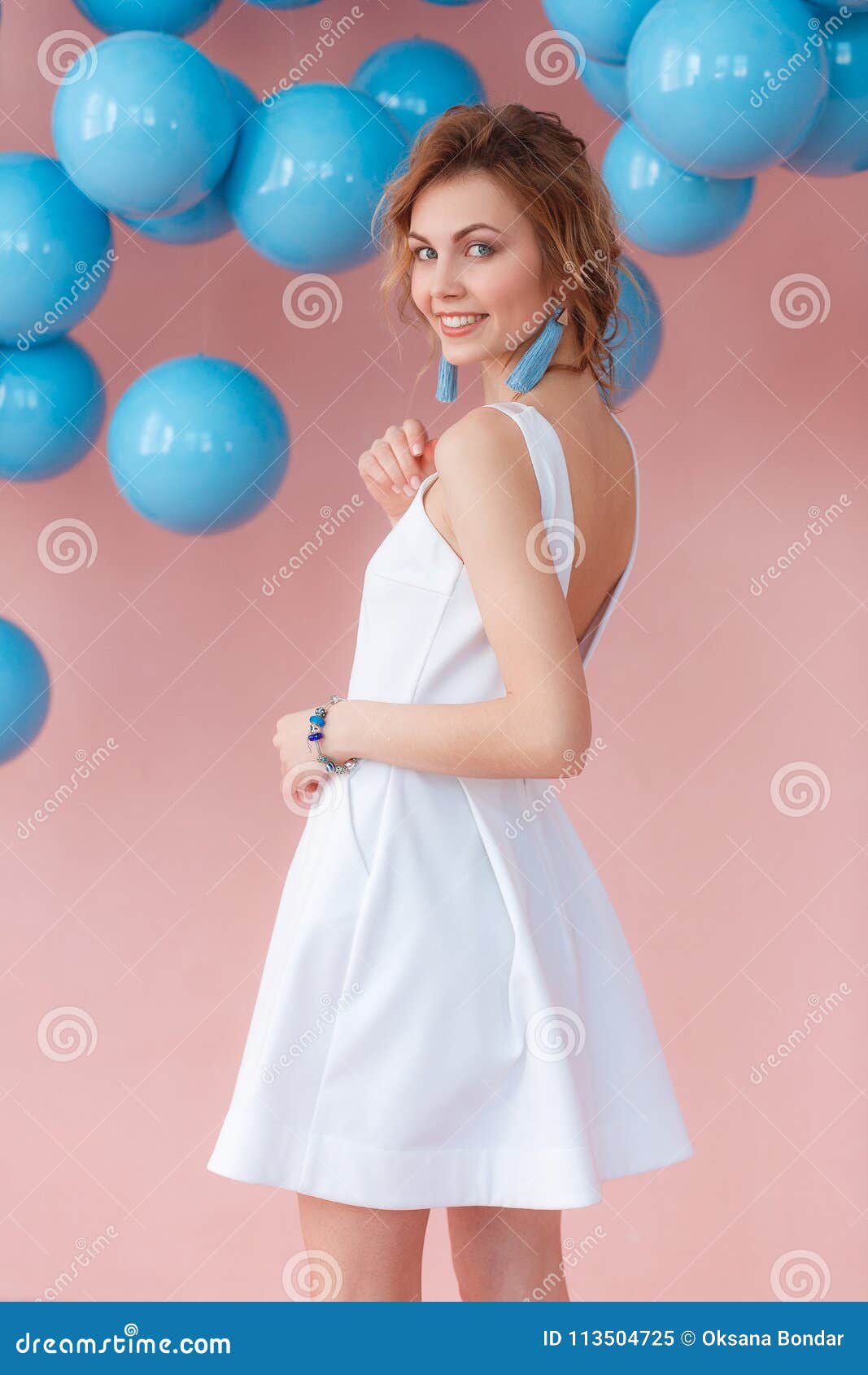 Young Woman in White Cocktail Dress Posing on Pink Wall Background with  Blue Balls Hanging Stock Image - Image of clothes, female: 113504725