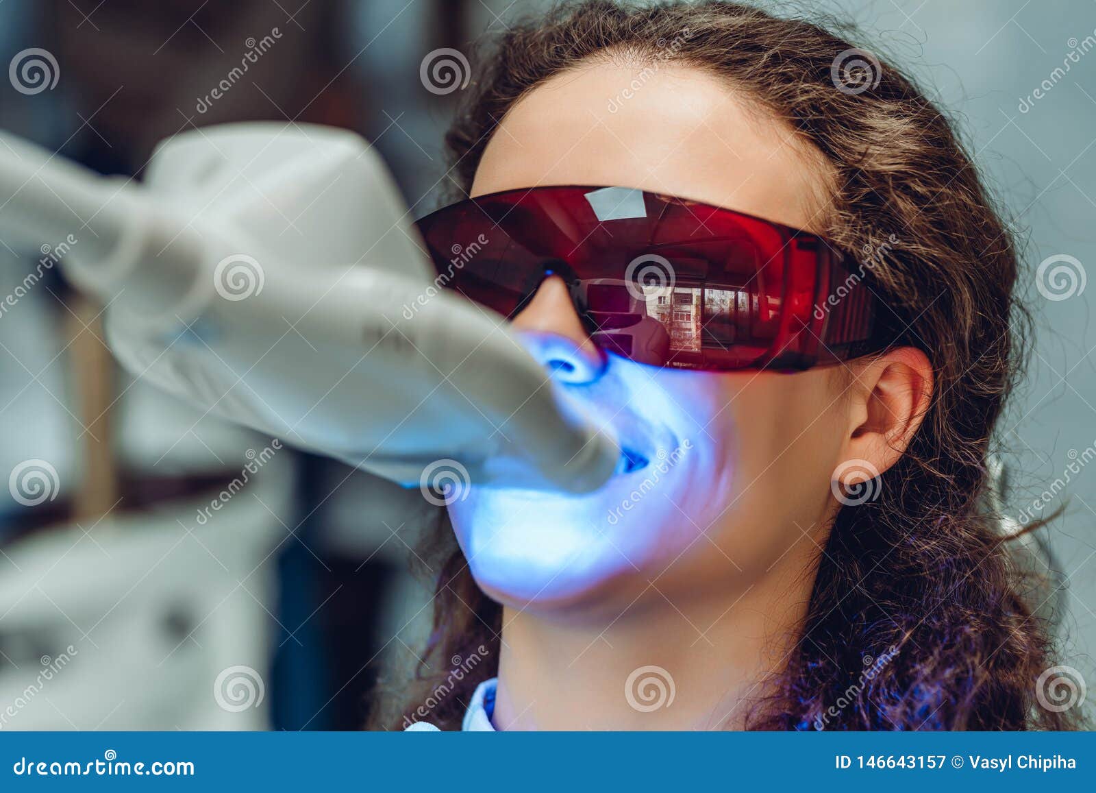 young woman whiten teeth at the dentist. close up view