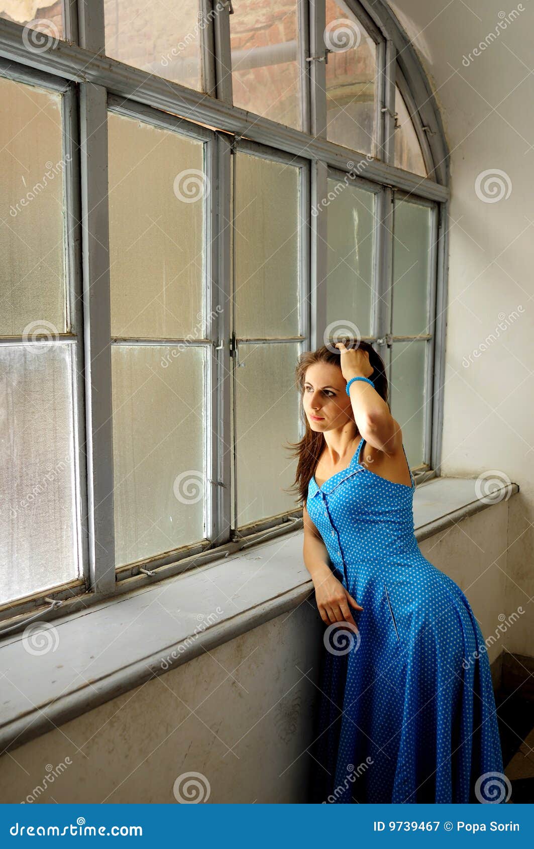 Young woman by the window stock image. Image of beauty - 9739467