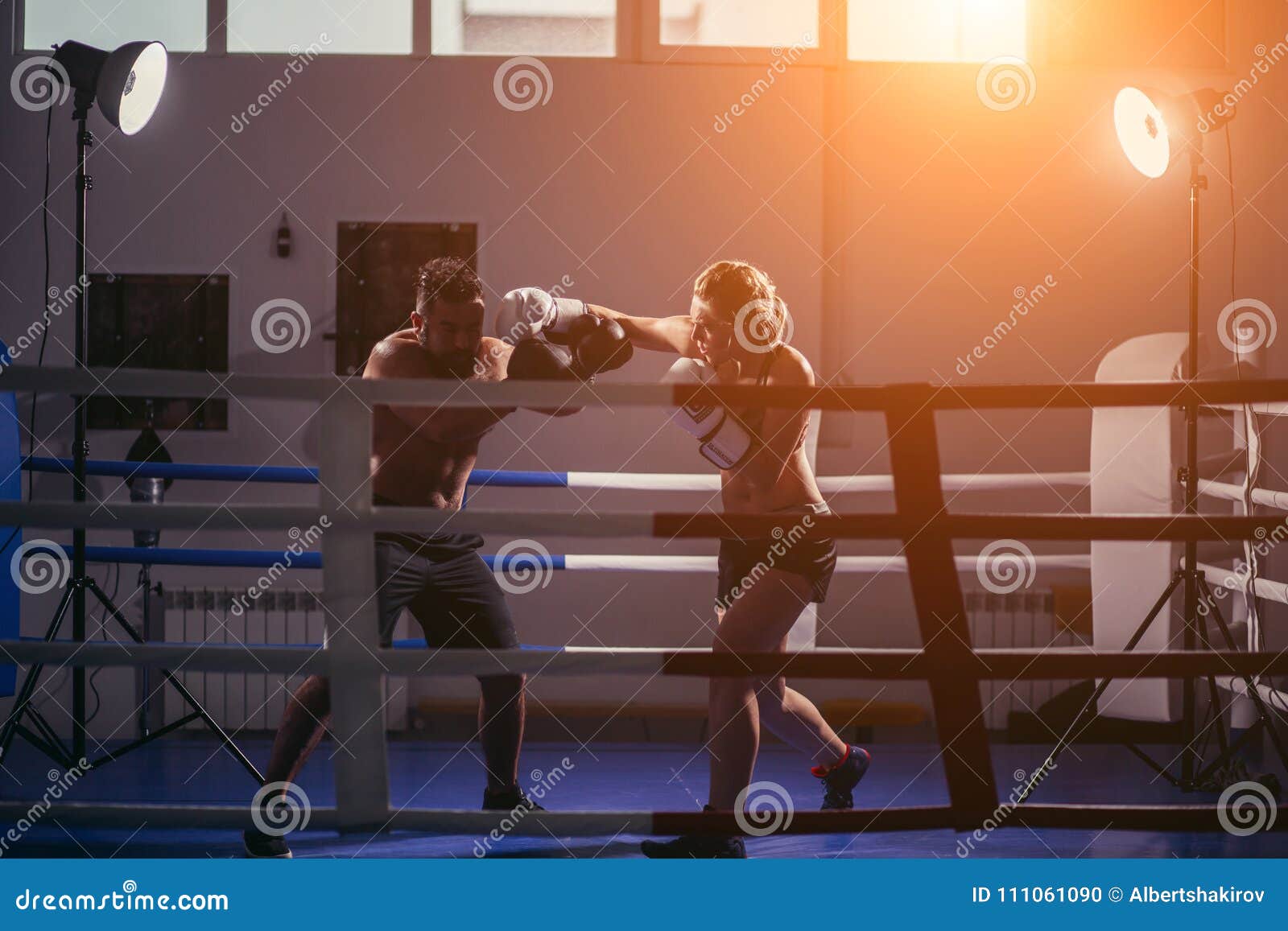 woman exercising with trainer at boxe and self defense lesson. copy space