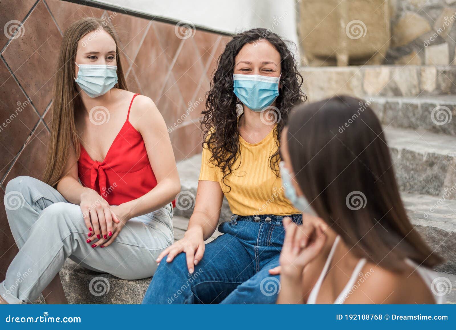young women with face mask during summer vacation during covid-19. focus selectivo