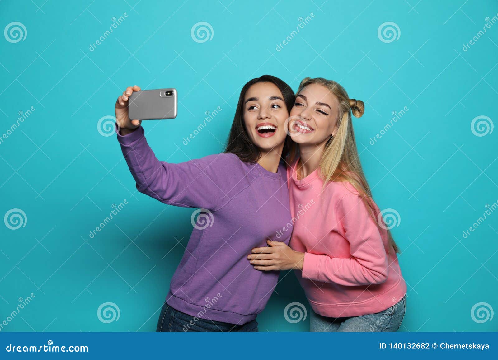 Young Women Laughing while Taking Selfie Stock Photo - Image of ...