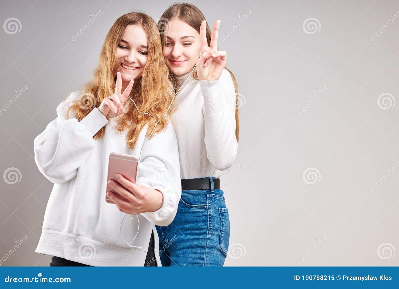 Young Women Listening To Music Together Streaming Content Talking with ...