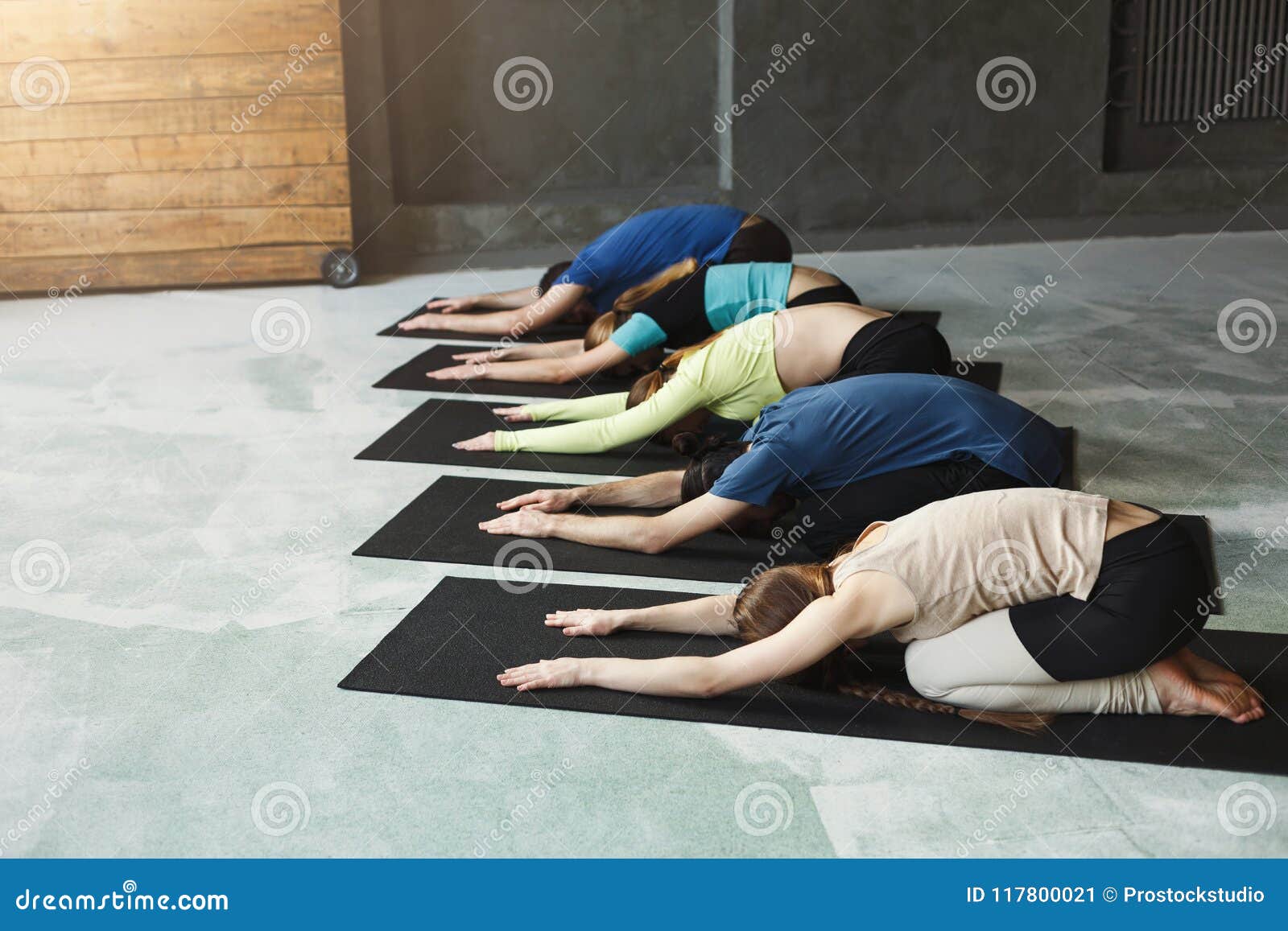 Three young fitness girls holding yoga mat while standing in gym Stock  Photo - Alamy