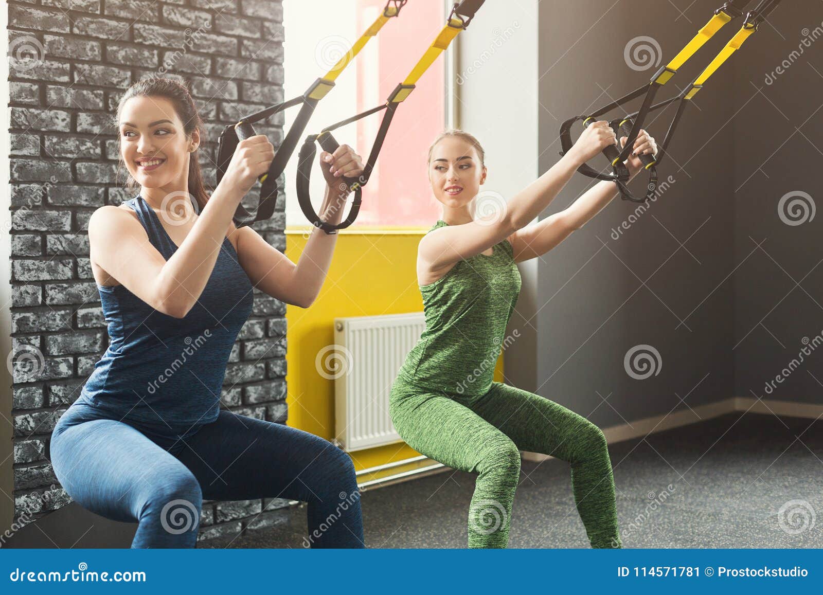 Women Performing TRX Suspension Training in Gym Stock Image