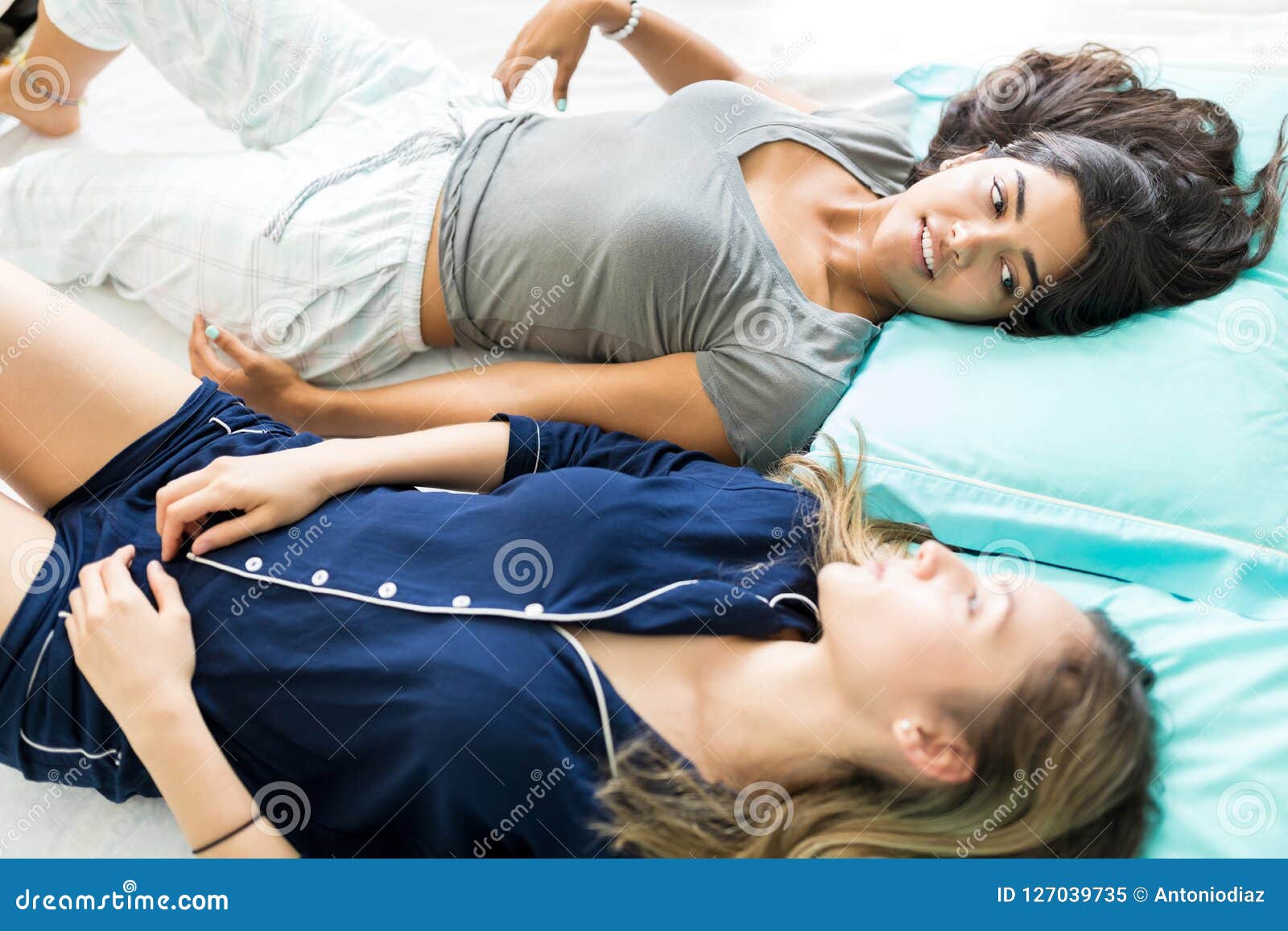 Woman Sharing Problems with Friend while Lying on Bed Stock Image