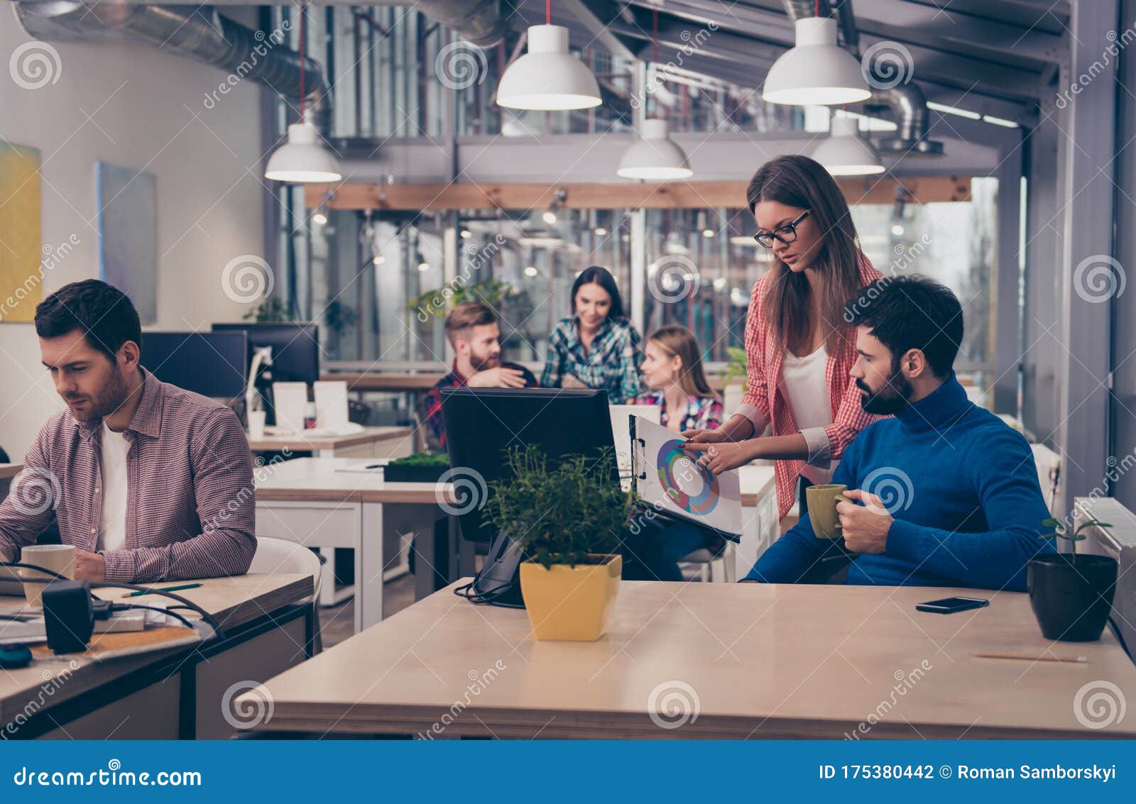 young woman showing diagrama of growth to her colleague