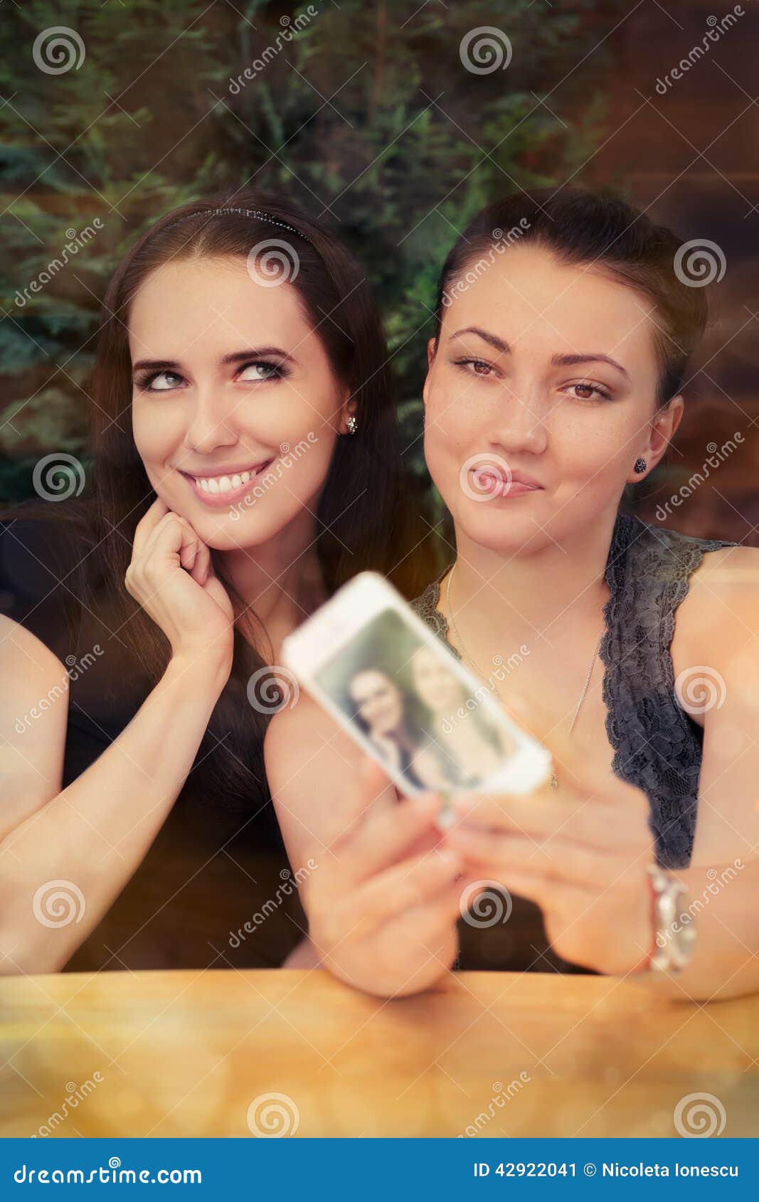 Young Women Taking A Funny Selfie Together Stock Photo Young Women Taking A Funny Selfie Together Stock Photo