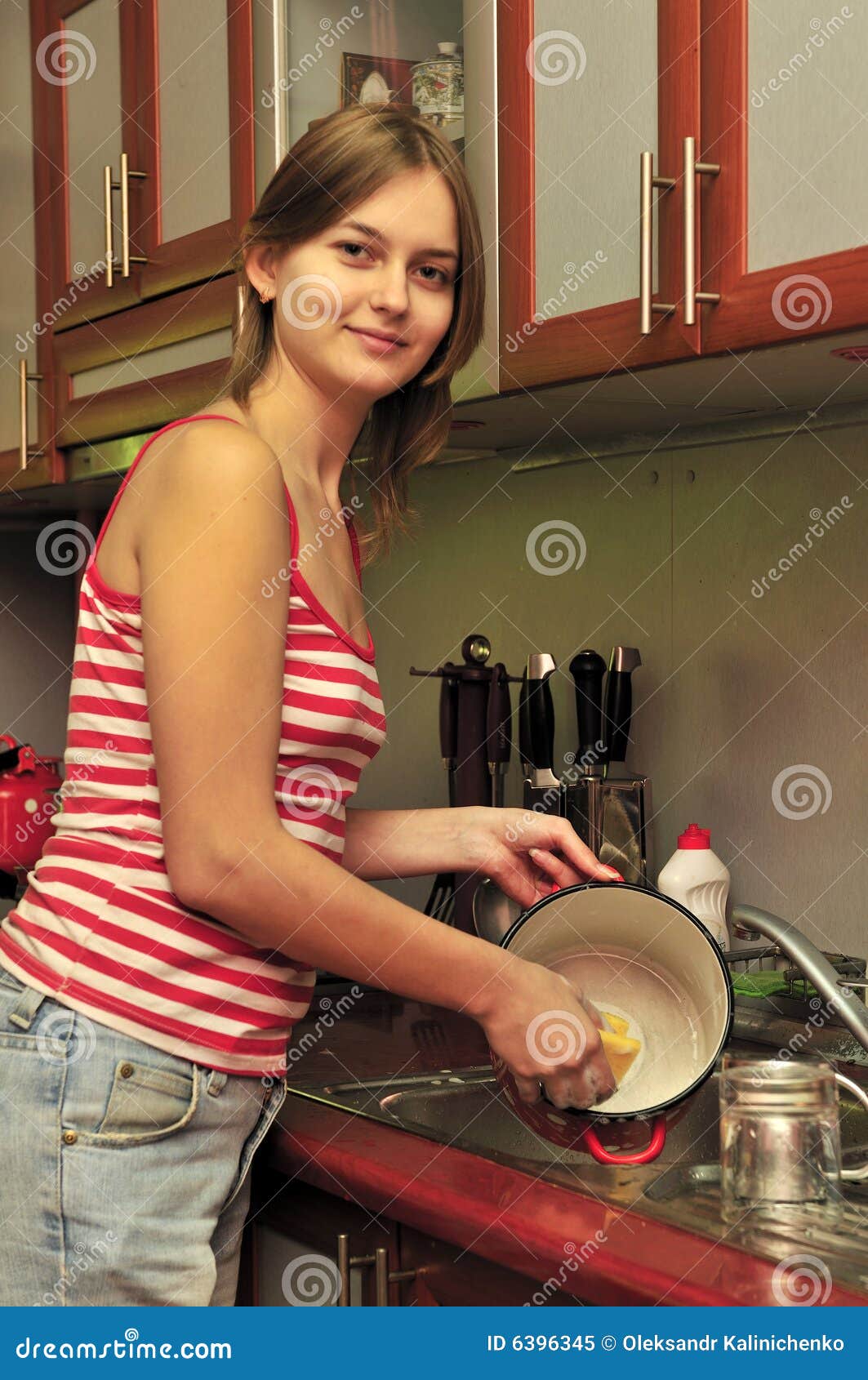 Attractive Young Woman Is Washing Dishes While Doing Cleaning At Home Stock  Photo, Picture and Royalty Free Image. Image 91906745.