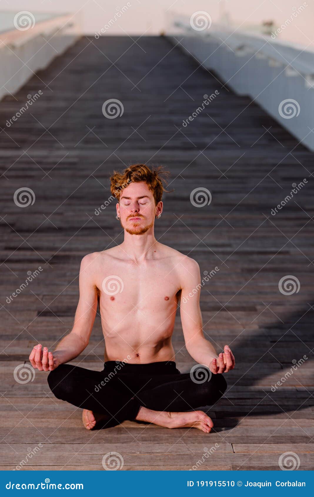 Young Yoga Practitioner Training Her Poses, Legs Crossed Sitting on a ...