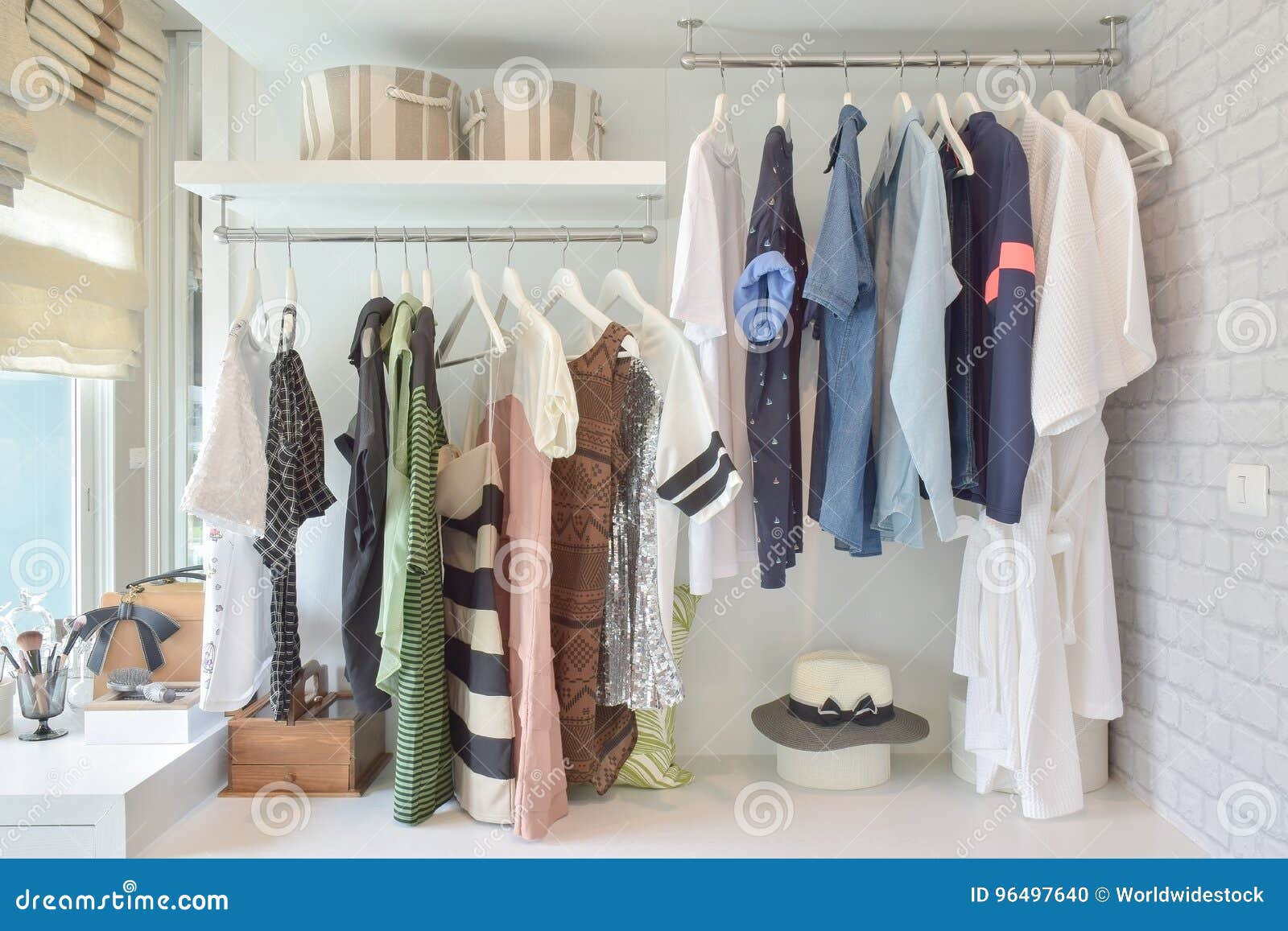 youth cloths hanging in open wardrobe in bedroom