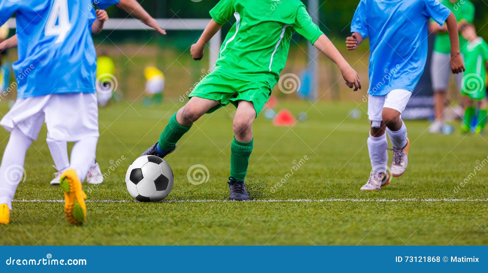 youth soccer football teams kicking soccer ball on sports field