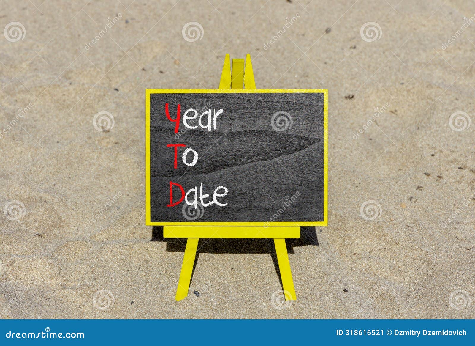 ytd year to date . concept words ytd year to date on beautiful yellow blackboard. beautiful sand background. business ytd