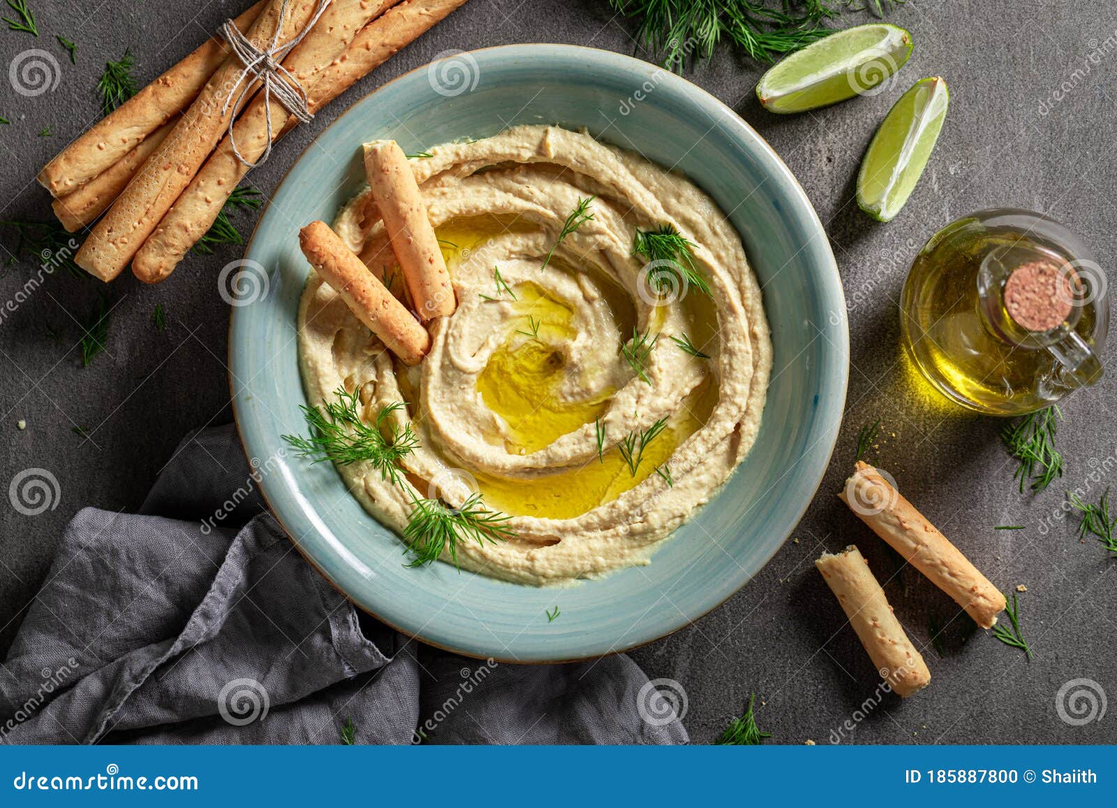 Yummy and Traditional Hummus with Breadsticks and Dill Stock Photo