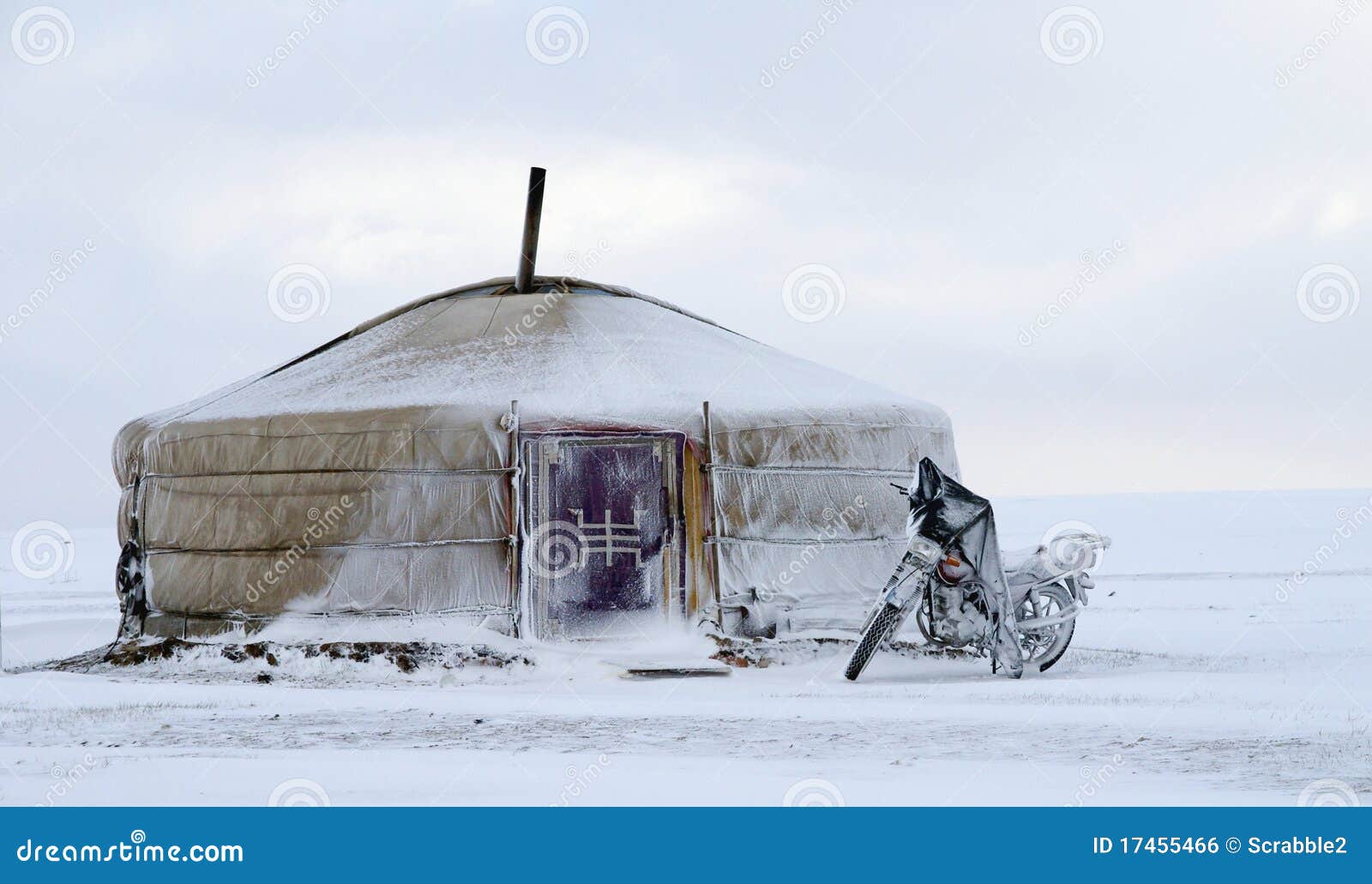 yurt in the snow with a motorcycle in mongolia