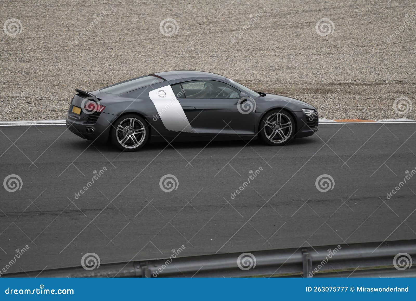 black and grey audi r8 riding on the circuit of zandvoort in the netherlands