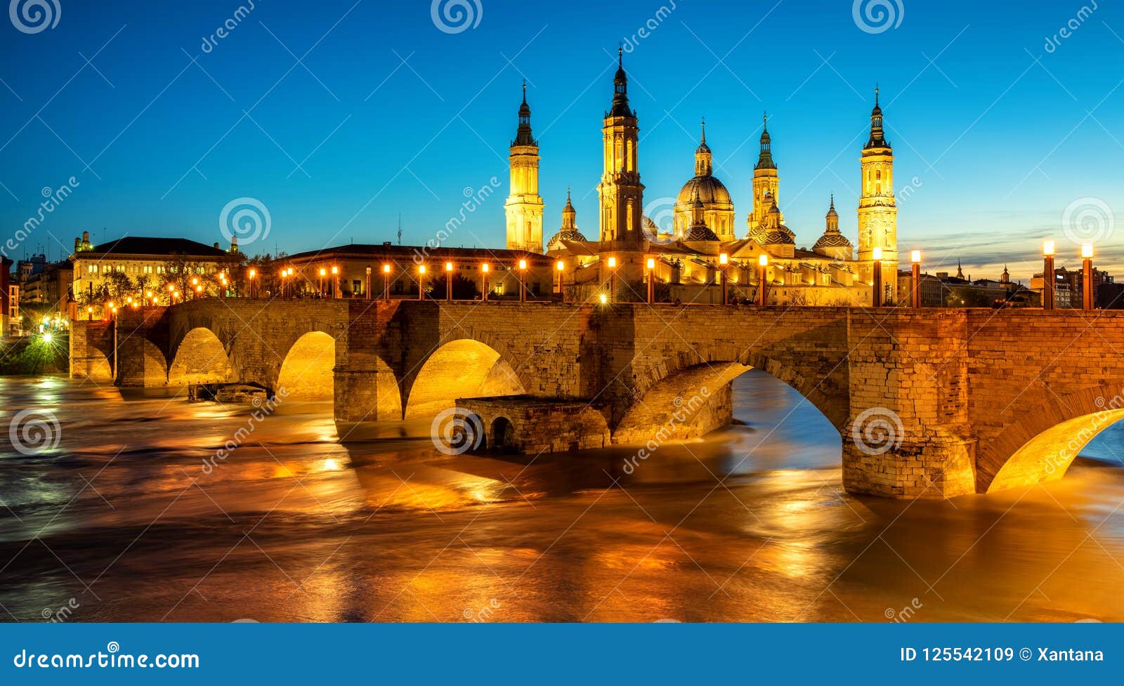 zaragoza city, spain, bridge and cathedral del pilar at sunset