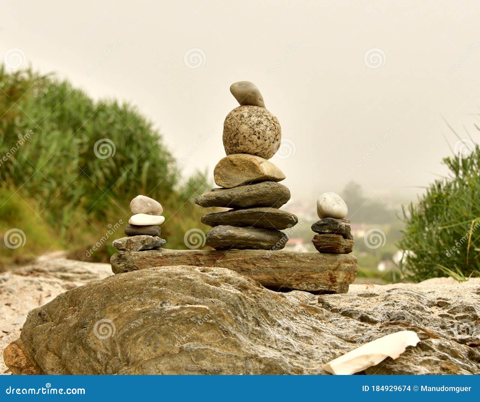 Zen Stones Balance Stones On Stone Stones Balance Pile Of Pebbles On Sand And A Bottom Of Green Vegetation Stock Photo Image Of Beauty Architecture
