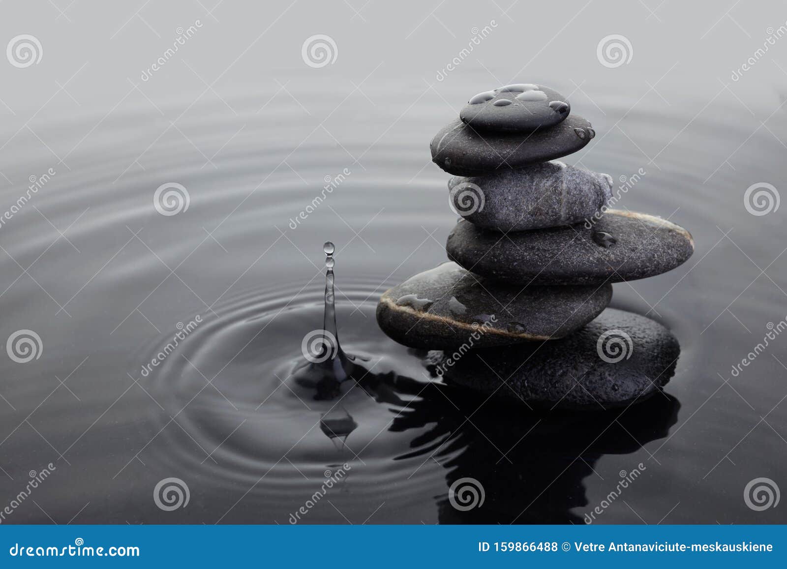 Zen Stones in Balanced Pile in Water on Rippled Water Surface and Water