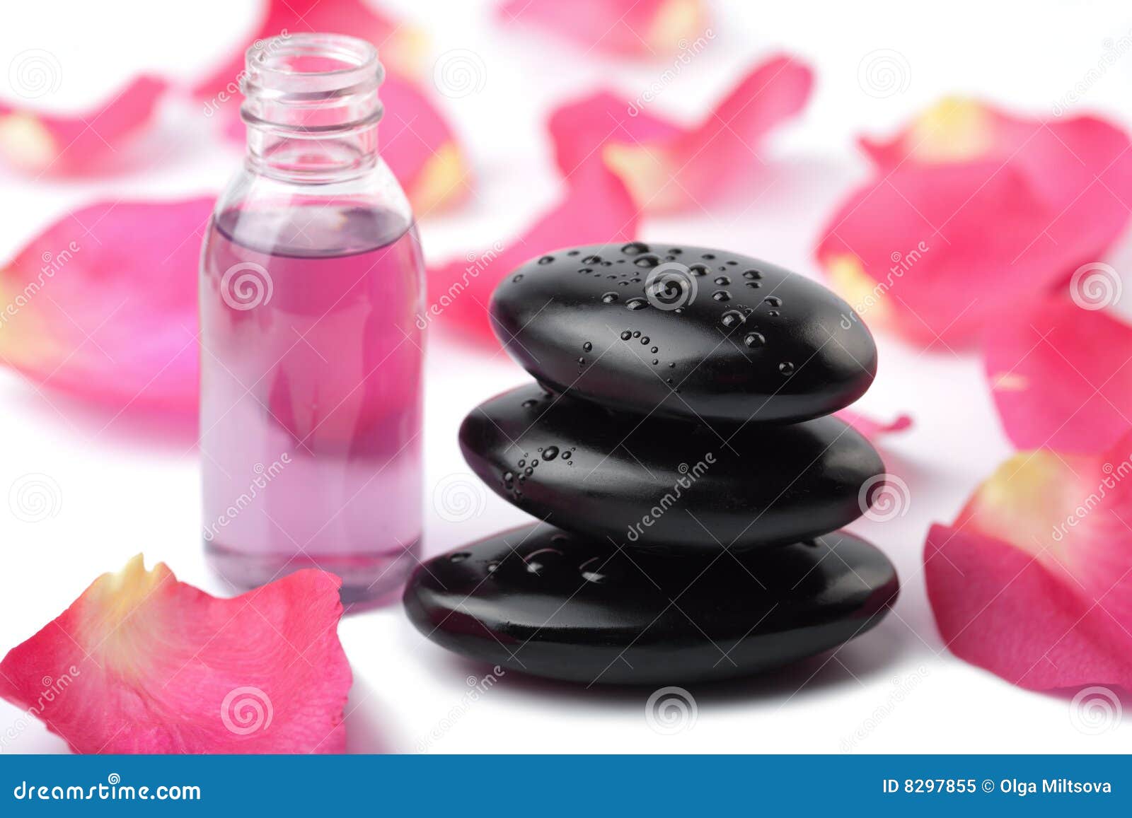 Zen stones, essential oil and rose petals isolated on white