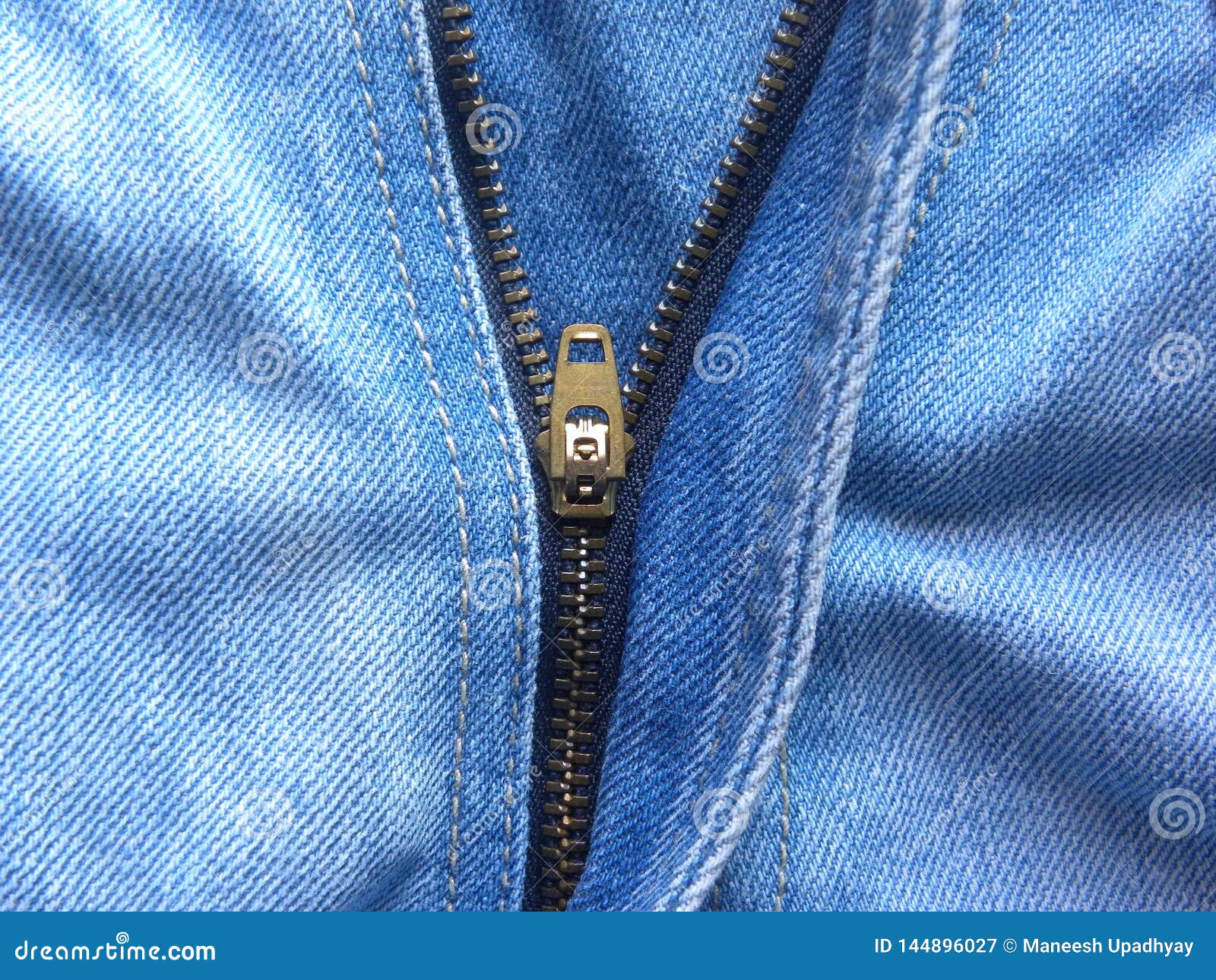 Zipper on light blue jeans stock image. Image of edges - 144896027