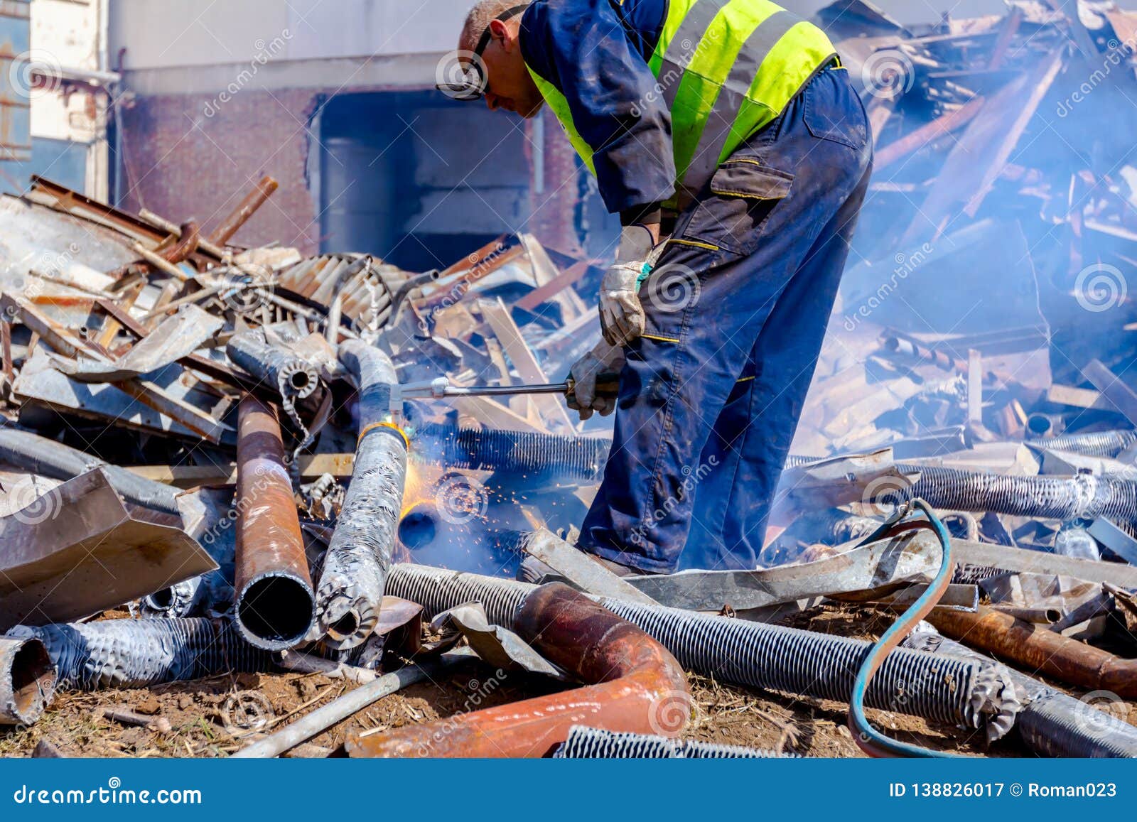 Worker is Cutting Scrap Metal with Acetylene Torch Editorial