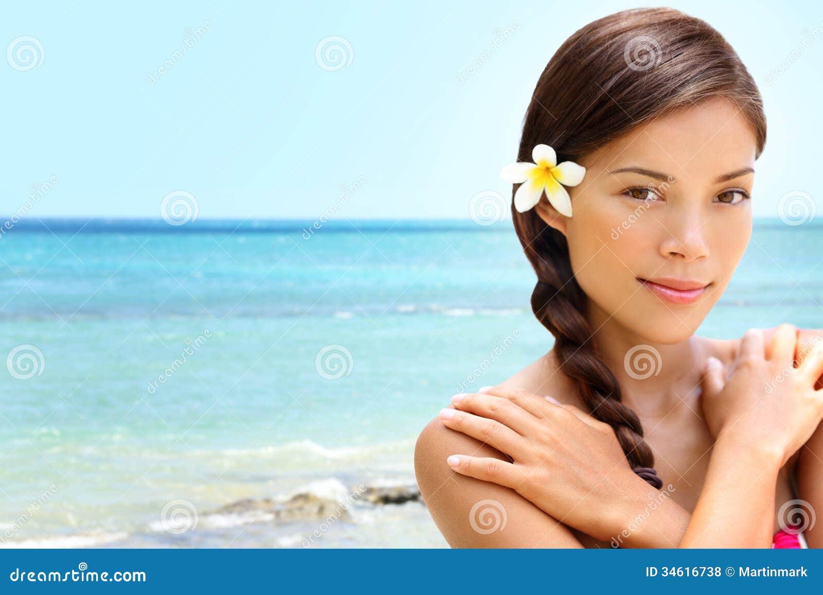 Γυναίκα ομορφιάς παραλιών wellness spa στην παραλία της Χαβάης. Όμορφη γαλήνια και ειρηνική νέα μικτή ασιατική καυκάσια θηλυκή πρότυπη χαλάρωση φυλών στο θέρετρο ταξιδιού με σκοπό τις διακοπές. Λουλούδι στη σκοτεινή πλεγμένη τρίχα.