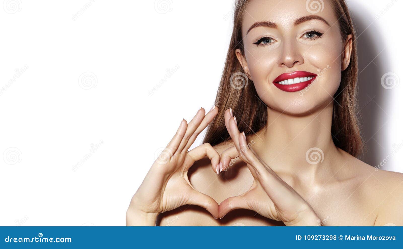 Ρομαντική νέα γυναίκα που κάνει τη μορφή καρδιών με τα δάχτυλά της Σύμβολο αγάπης και ημέρας βαλεντίνων Κορίτσι μόδας με το ευτυχ