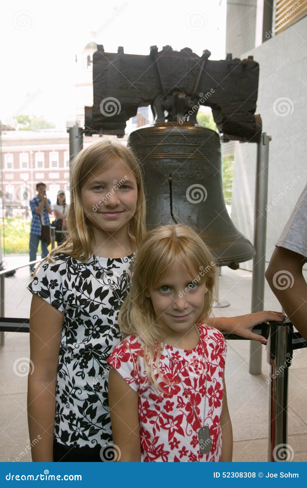 2 белокурых сестры стоят перед свободой колоколом, на волю самоцентрирующийся кернер, перед независимостью Hall в исторической зо. 2 белокурых сестры стоят перед свободой колоколом, на волю самоцентрирующийся кернер, перед независимостью Hall в исторической области Филадельфии, Пенсильвания
