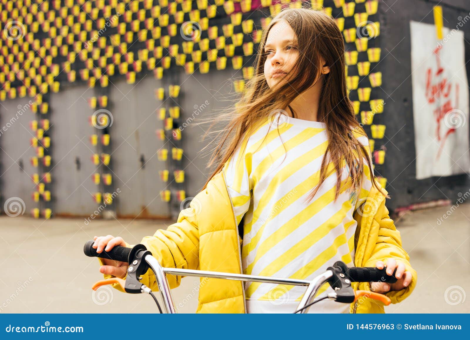 Brown-haired girl in a Yellow Jacket sucks