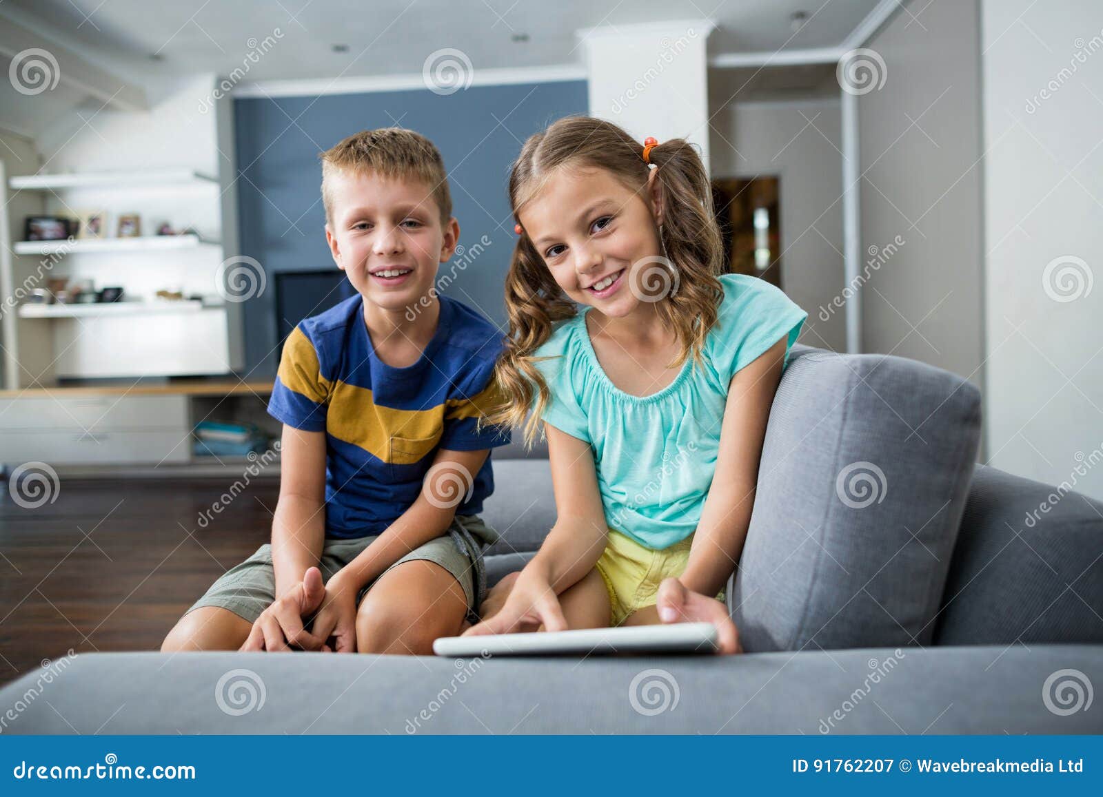 Siblings lying on the Sofa Фотобанк Лори