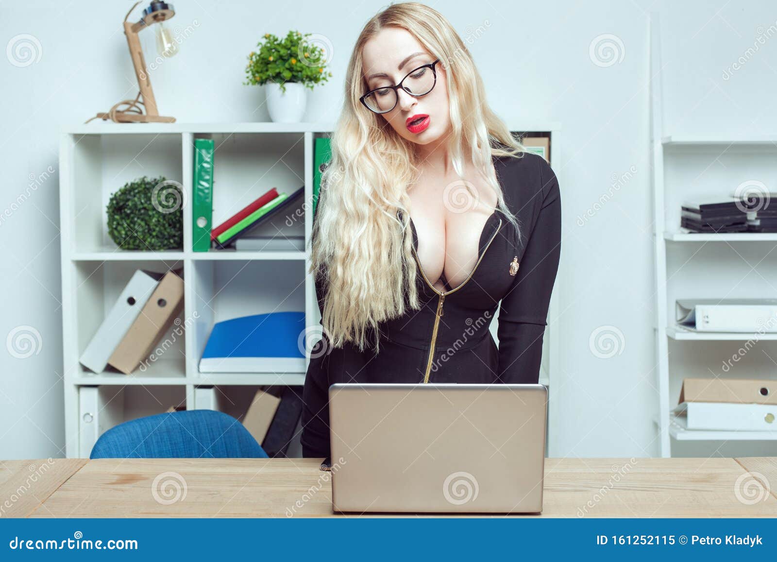 Сексуальный офисный работник или секретарь позирует в офисе